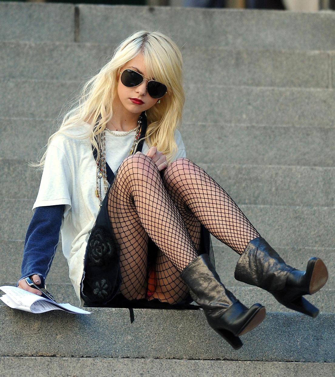 Blonde Teen Girl Upskirt wearing Black Fishnet Pantyhose and Black Skirt